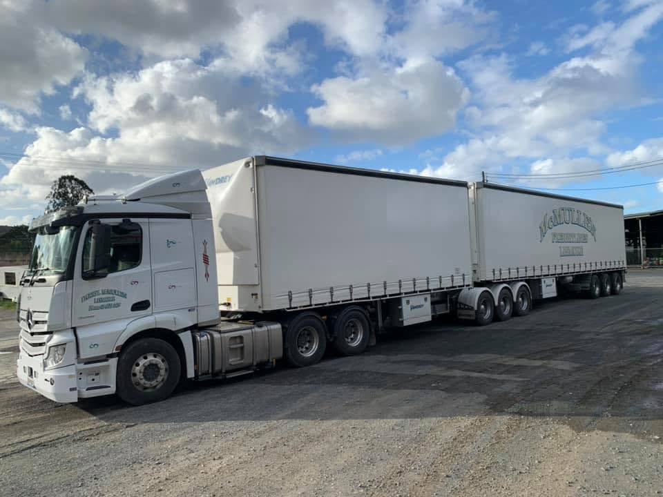 McMullens heavy haulage Mercedes-Benz B-double curtain-sider truck for oversized transport